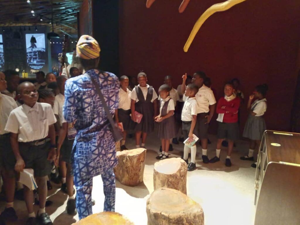 J Randle Museum Visit: Projector display of Yoruba gods and Olorun in future exhibit. Tour Africa Mag.