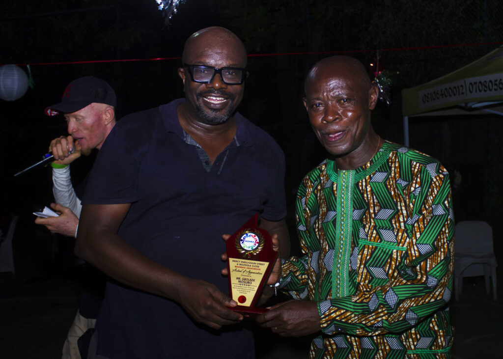 MOMRA residents enjoy a lively Christmas party featuring fun activities, awards, karaoke, and festive cheer in a vibrant atmosphere.