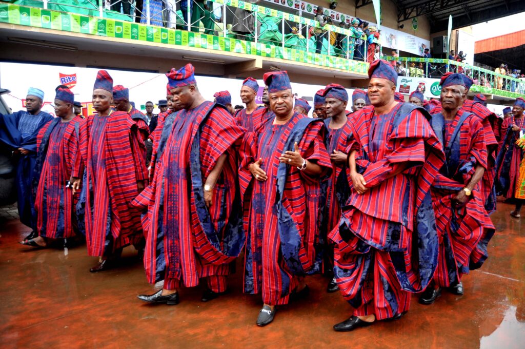 Egbe gbobaniyi okunrin in colourful Yoruba attire parading at Ojude Oba Festival. Tour Africa Mag