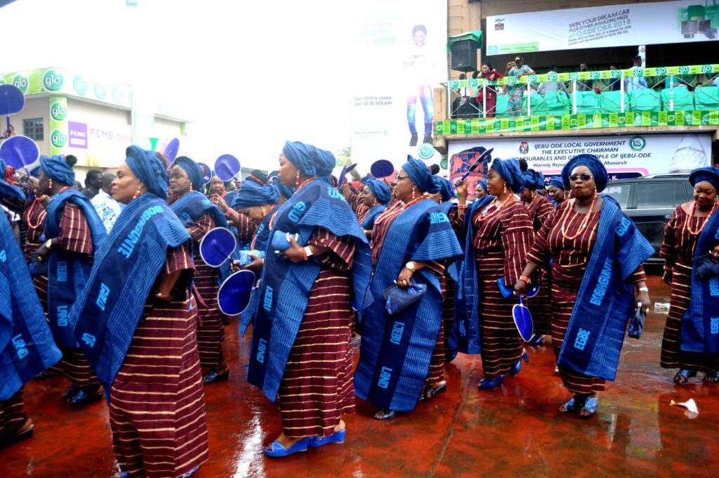 Egbe obinrin in colourful Yoruba attire parading at Ojude Oba Festival. Tour Africa Mag