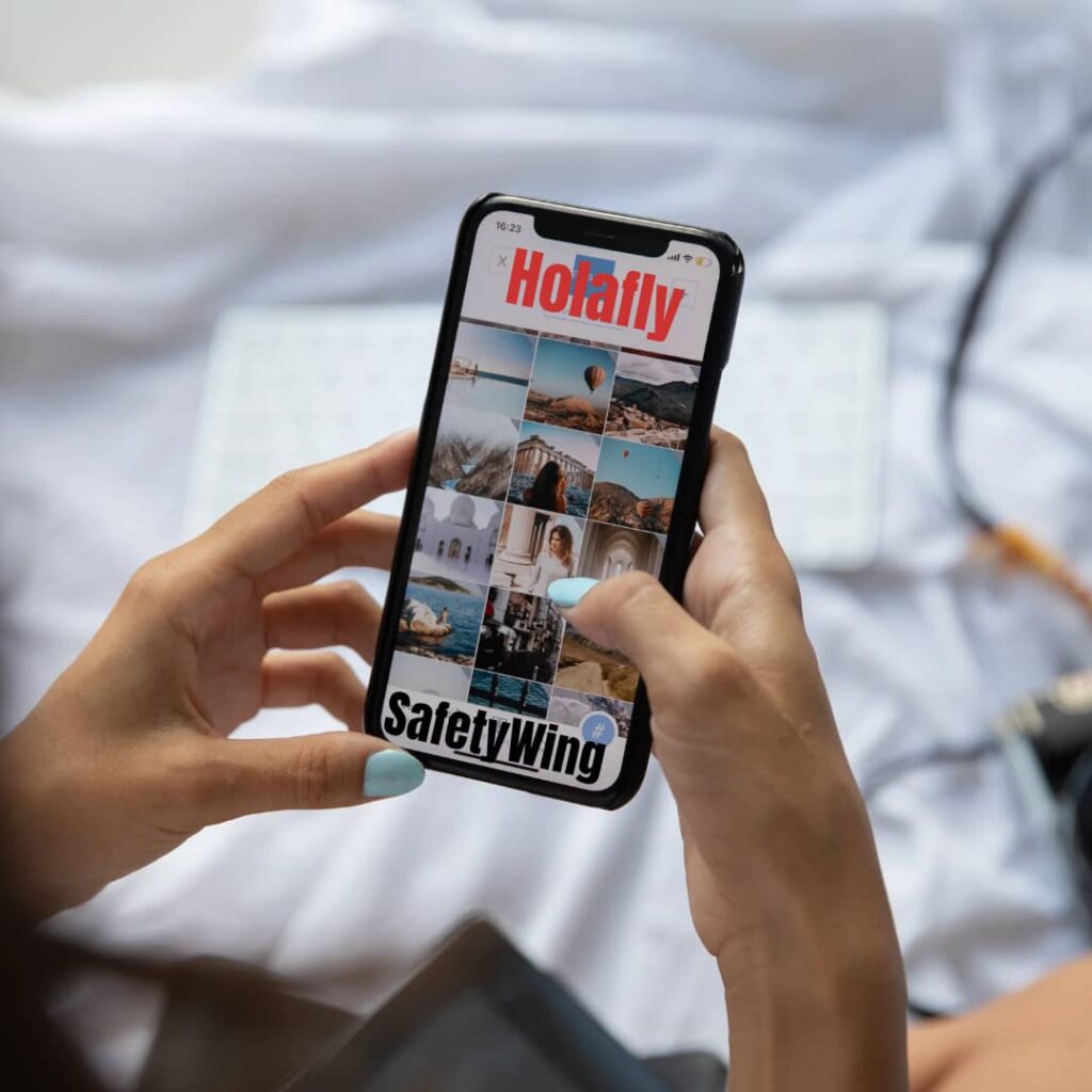 Tech-Enabled Travel: Mobile Phone showing Holafly and SafetyWing interface- Image created from Canva- Tour Africa Mag.