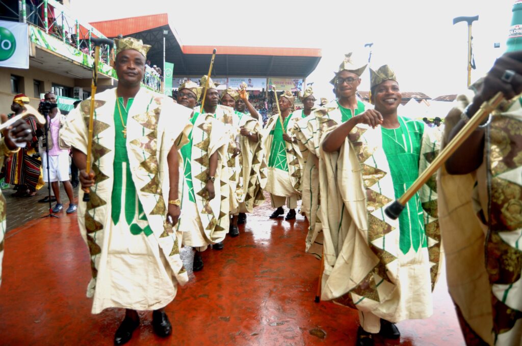 Egbe okunrin in colourful Yoruba attire parading at Ojude Oba Festival. Tour Africa Mag.