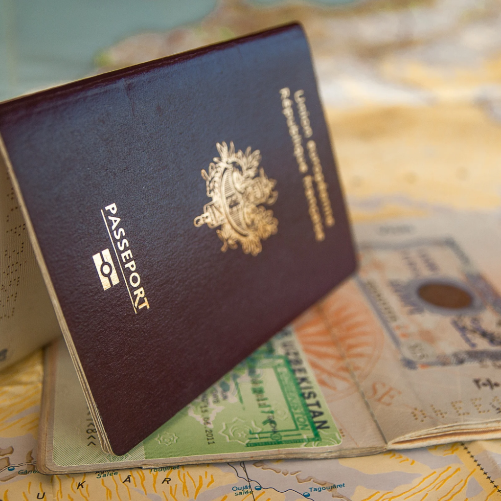 Dubai Tourists Visa for Nigerians 2025: Close-up of a passport with a visa stamp, symbolizing travel approval and visa connection. Tour Africa Magazine